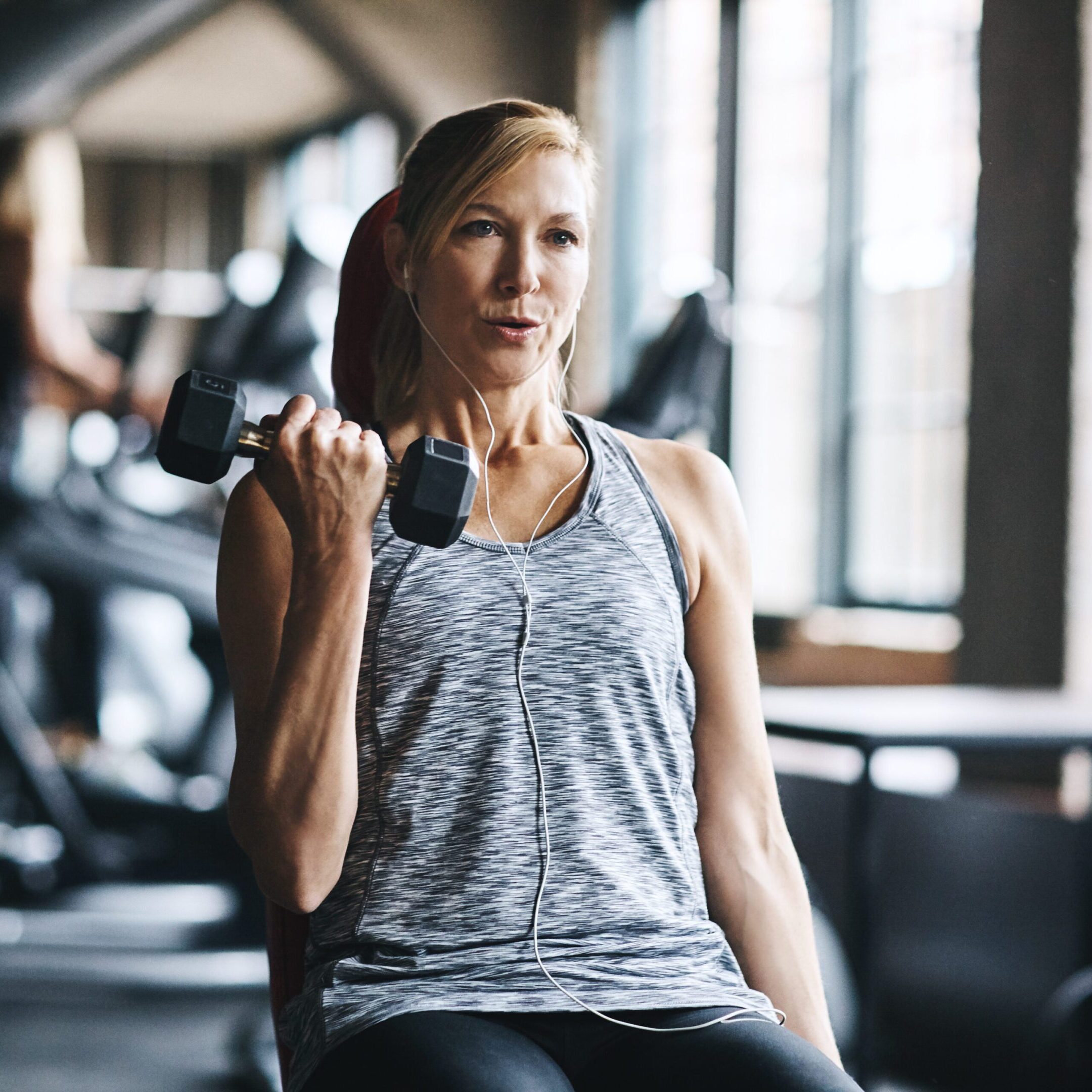 Getting fit by lifting A woman is holding a weight in her hand.
